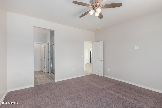 unfurnished bedroom featuring light carpet and ceiling fan