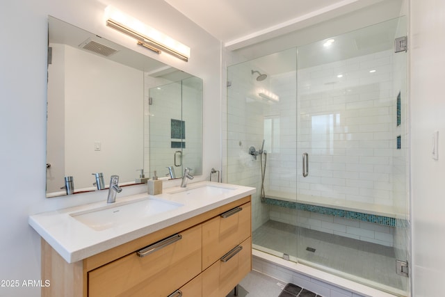 bathroom with vanity and a shower with door