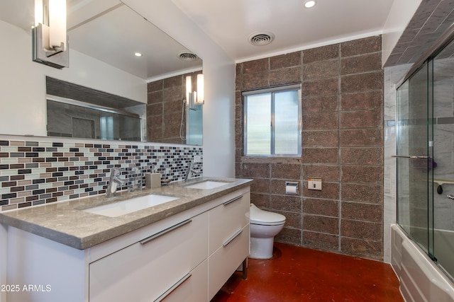 full bathroom featuring backsplash, bath / shower combo with glass door, vanity, concrete floors, and toilet