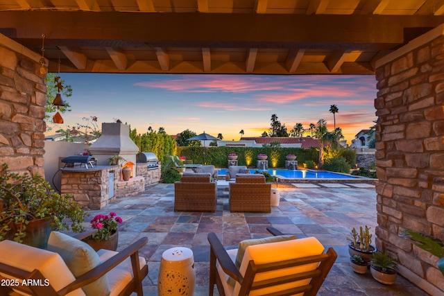 view of patio with exterior kitchen, a fenced backyard, and grilling area