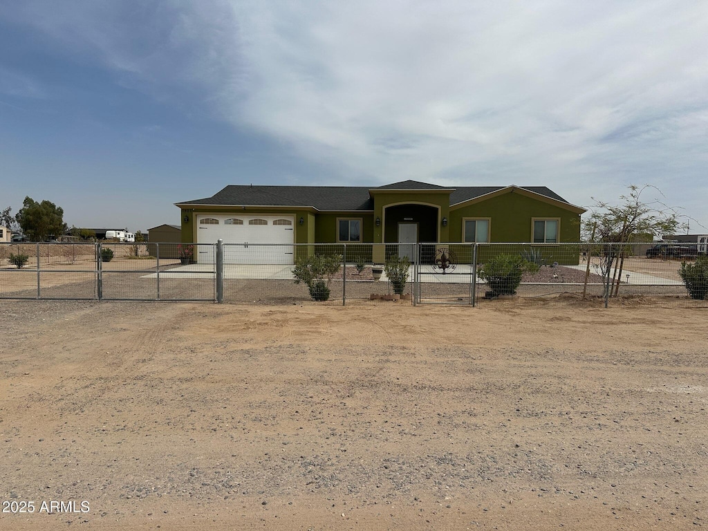 ranch-style house featuring a gate, fence, and dirt driveway