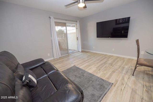 living room featuring ceiling fan and light hardwood / wood-style flooring