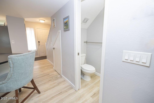 bathroom featuring wood-type flooring and toilet