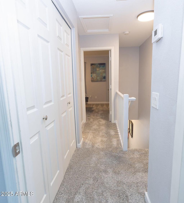 hallway with light colored carpet