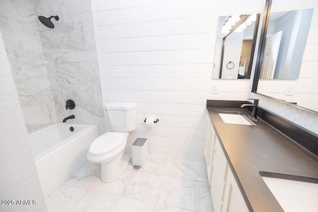 full bathroom with vanity, toilet, and tiled shower / bath combo