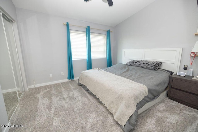 carpeted bedroom with ceiling fan and vaulted ceiling