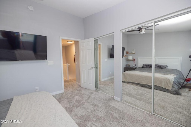 carpeted bedroom featuring two closets