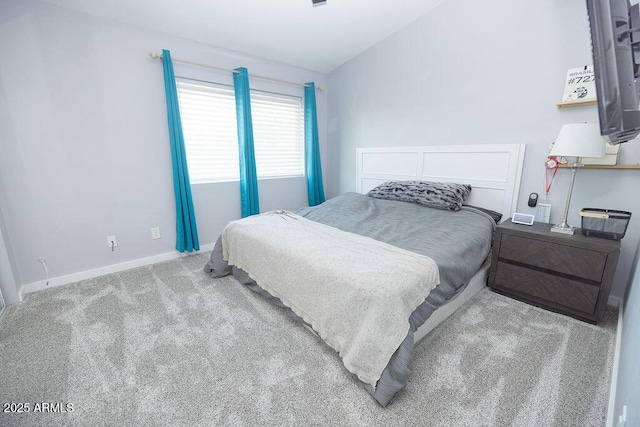 bedroom featuring vaulted ceiling and carpet