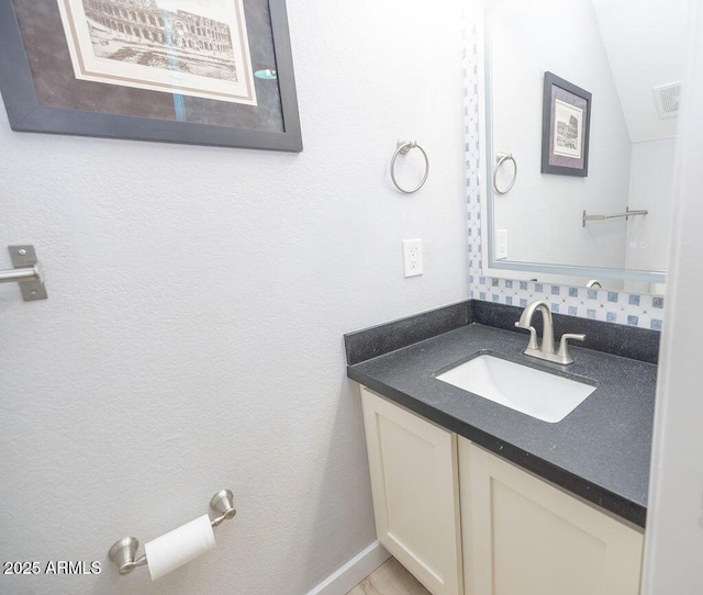 bathroom featuring vanity and vaulted ceiling