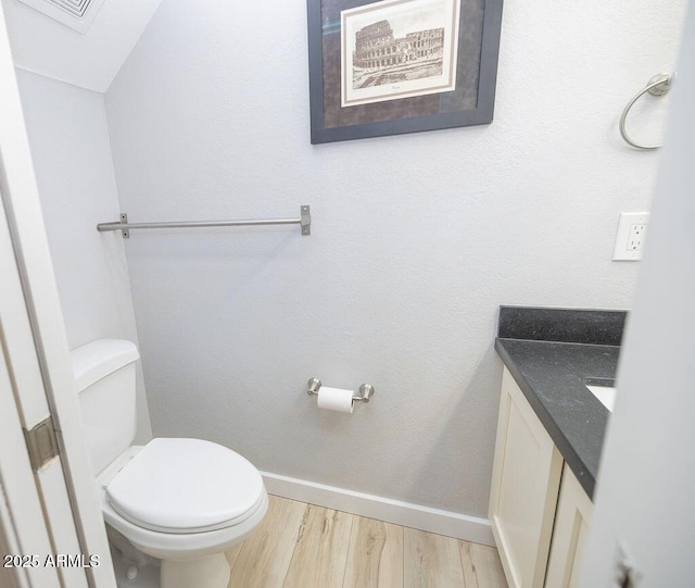 bathroom featuring hardwood / wood-style flooring, vanity, and toilet