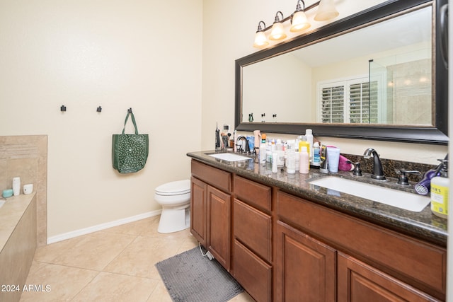 bathroom featuring tile patterned floors, an enclosed shower, vanity, and toilet