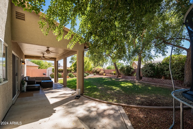 view of yard featuring ceiling fan, an outdoor hangout area, and a patio area