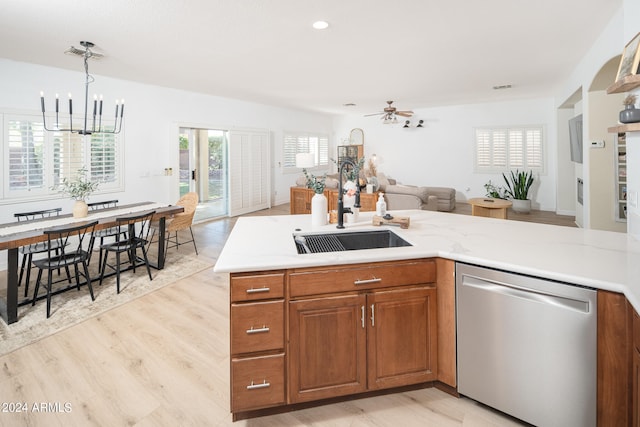 kitchen featuring light hardwood / wood-style floors, ceiling fan with notable chandelier, dishwasher, pendant lighting, and sink