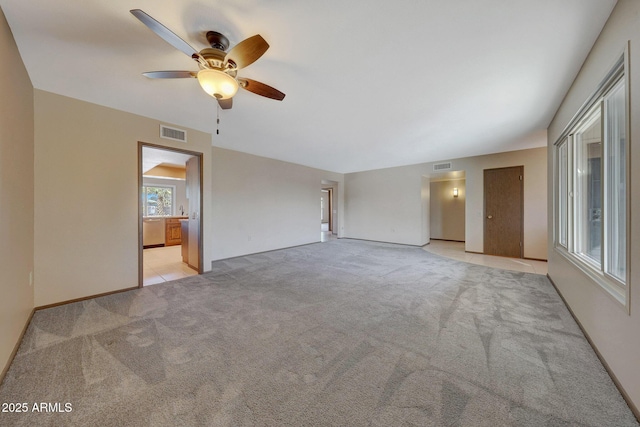 interior space featuring light carpet, visible vents, and a ceiling fan