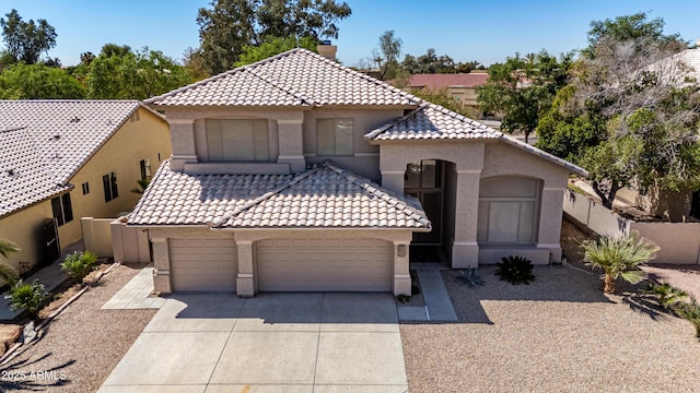 mediterranean / spanish-style house with concrete driveway, a chimney, stucco siding, a tiled roof, and a garage