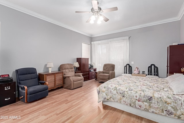 bedroom featuring crown molding, wood finished floors, and a ceiling fan