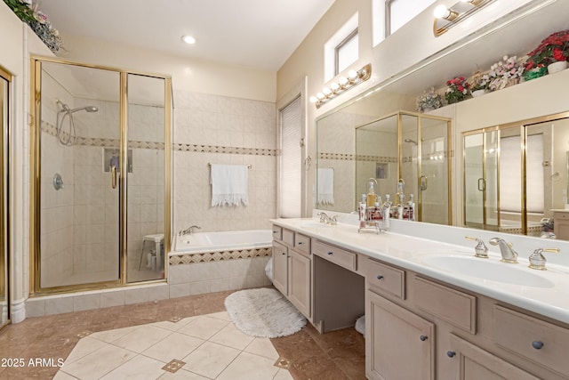 full bathroom featuring tile patterned floors, a sink, a garden tub, and a shower stall