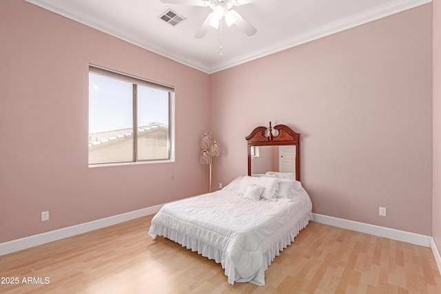bedroom with visible vents, baseboards, ornamental molding, a ceiling fan, and light wood-style floors