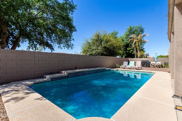 view of pool with a patio, a fenced in pool, and a fenced backyard