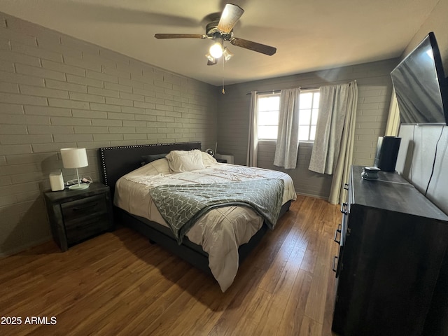 2564 Mockingbird Dr, Sierra Vista, AZ 85635 - bedroom featuring dark wood finished floors, brick wall, and ceiling fan