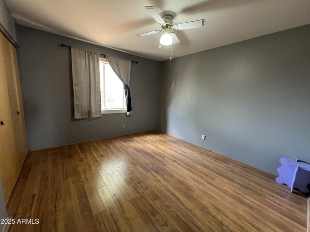 2564 Mockingbird Dr, Sierra Vista, AZ 85635 - unfurnished bedroom featuring wood finished floors and a ceiling fan