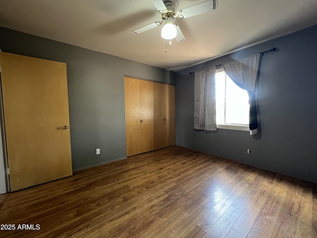 2564 Mockingbird Dr, Sierra Vista, AZ 85635 - unfurnished bedroom with wood finished floors, a closet, and ceiling fan