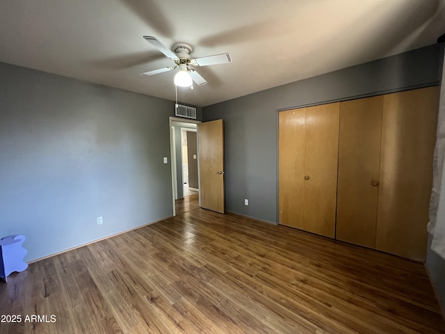 2564 Mockingbird Dr, Sierra Vista, AZ 85635 - unfurnished bedroom with wood finished floors, a closet, ceiling fan, and baseboards
