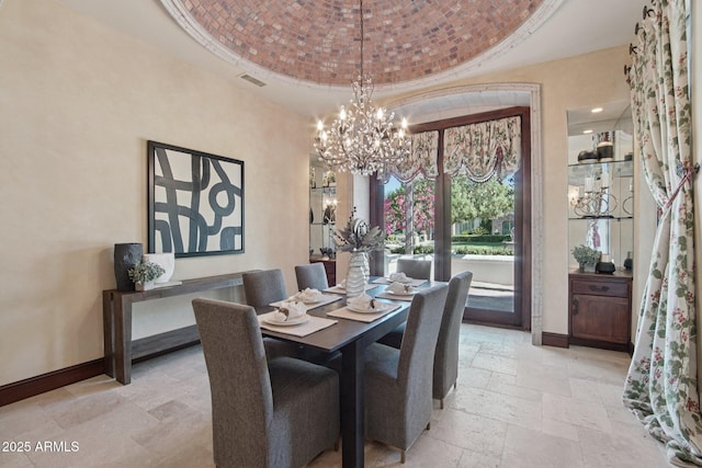 1330 N 40th St Unit 1, Mesa, AZ 85205 - dining area featuring stone tile flooring, a chandelier, brick ceiling, and a raised ceiling