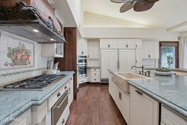 1330 N 40th St Unit 1, Mesa, AZ 85205 - kitchen featuring appliances with stainless steel finishes, exhaust hood, vaulted ceiling, decorative backsplash, and dark wood-type flooring