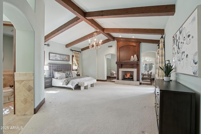 1330 N 40th St Unit 1, Mesa, AZ 85205 - bedroom featuring light colored carpet, arched walkways, a chandelier, a large fireplace, and a wainscoted wall