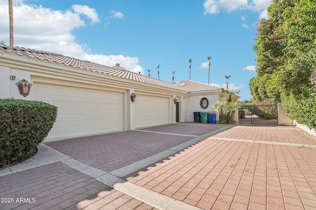 1330 N 40th St Unit 1, Mesa, AZ 85205 - view of front facade with decorative driveway, a garage, stucco siding, a tile roof, and a chimney