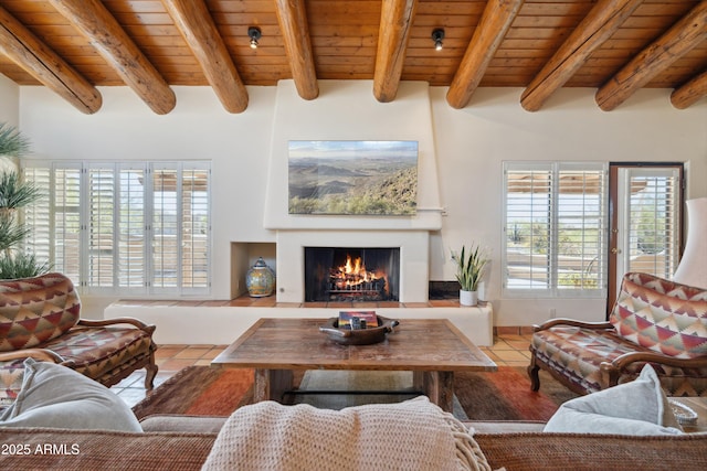 tiled living room with a warm lit fireplace, wooden ceiling, and beamed ceiling