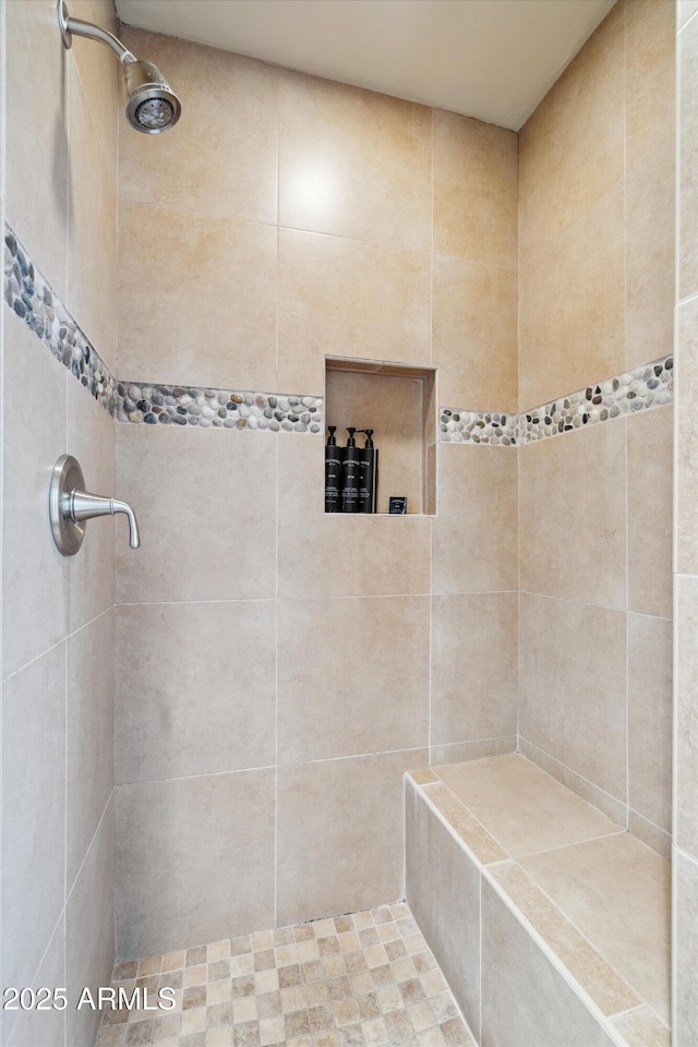 bathroom featuring tiled shower