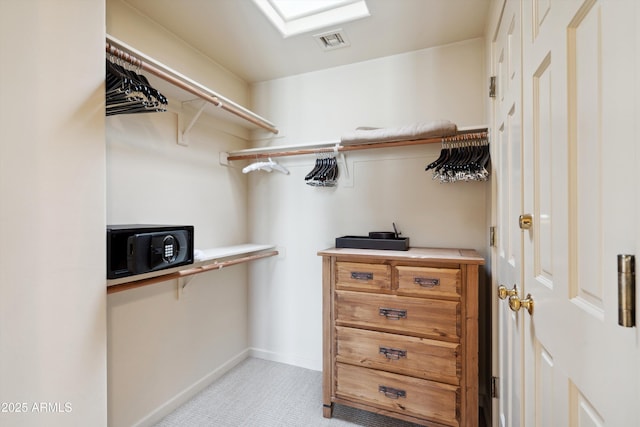 walk in closet featuring light carpet and visible vents