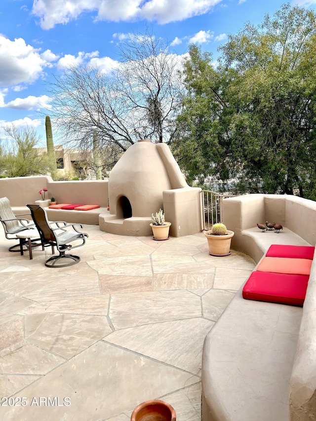 view of patio / terrace with an outdoor fireplace