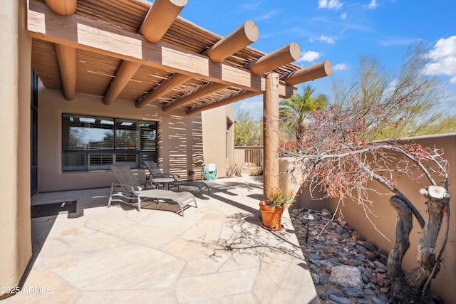 view of patio / terrace with fence and a pergola