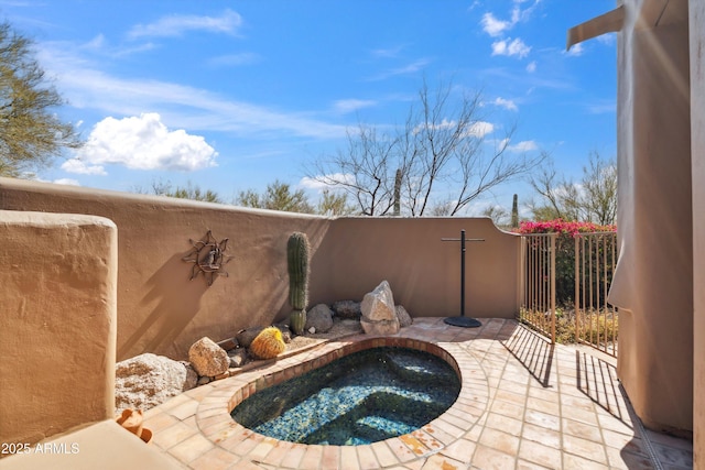 view of swimming pool featuring an in ground hot tub and a patio