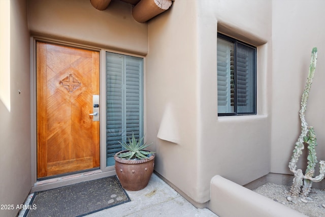 doorway to property with stucco siding