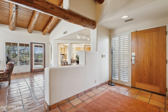 tiled foyer featuring lofted ceiling with beams, wooden ceiling, baseboards, and visible vents