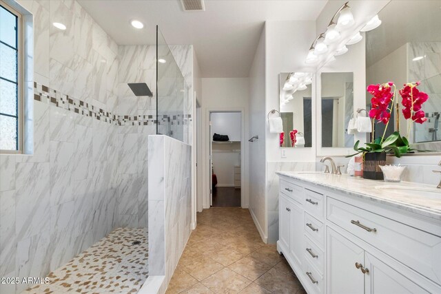 4032 S Santa Rita Pl, Chandler, AZ 85249 - bathroom featuring double vanity, a walk in shower, tile patterned flooring, a spacious closet, and recessed lighting