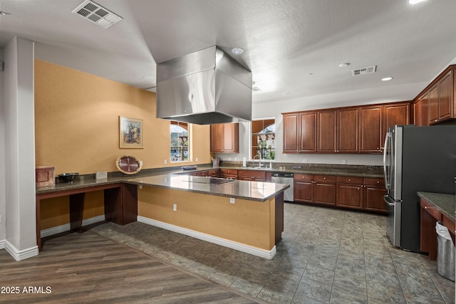 kitchen with visible vents, island exhaust hood, stainless steel appliances, and a sink