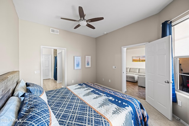 carpeted bedroom featuring visible vents, baseboards, and a ceiling fan