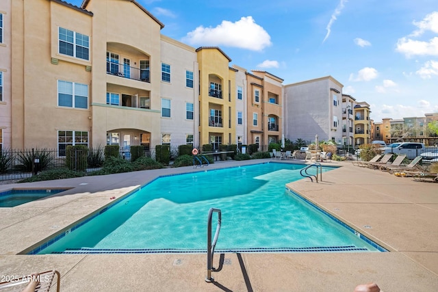 community pool featuring a patio area and fence