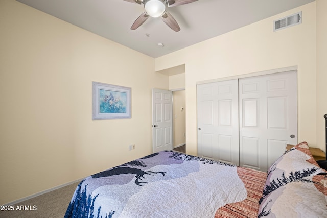 carpeted bedroom featuring a closet, visible vents, and a ceiling fan