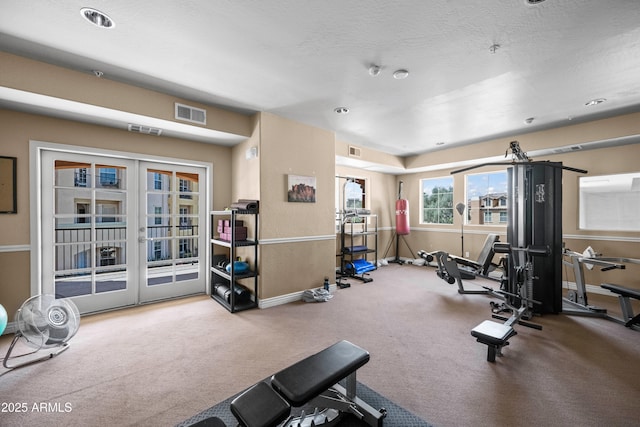 workout room featuring visible vents, baseboards, carpet floors, and french doors