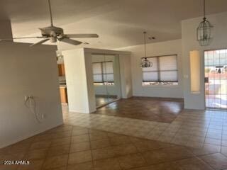 unfurnished room with ceiling fan and dark tile patterned floors