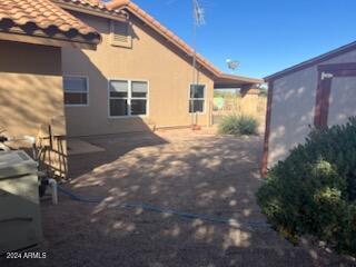 view of home's exterior featuring a tiled roof, a patio area, and stucco siding