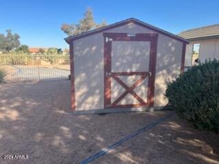 view of shed featuring fence