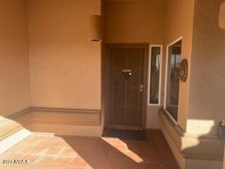 view of exterior entry featuring stucco siding