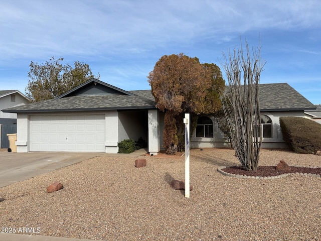 ranch-style home featuring roof with shingles, driveway, an attached garage, and stucco siding